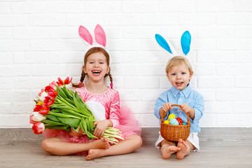 Happy easter! funny funny children   with ears hare getting ready for  holiday