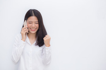 Fototapeta premium Beautiful asian young businesswoman excited and glad of success taking mobile phone on cement background, career freelance business concept.