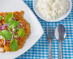 canned fish omelette and rice, spoon on table, thai food