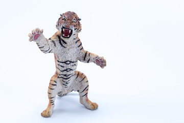 Toy tiger roaring and in attack position with white background