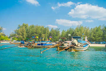 Fototapeta na wymiar Outdoor view of Fishing thai boats in a row in Po-da island, Krabi Province, Andaman Sea, South of Thailand