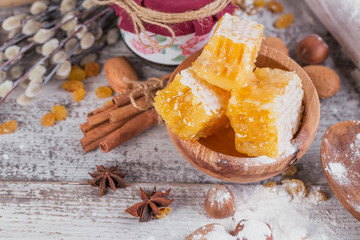 Ingredients for cooking bread or cookies: honeycomb, flour, raisines, mix of nuts, spices