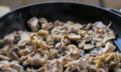 Preparation of roasted chopped meat in a frying pan.