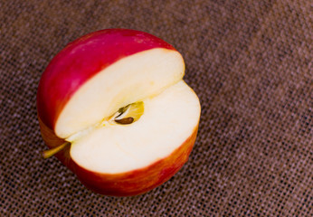 Apple cut on a dark brown background.