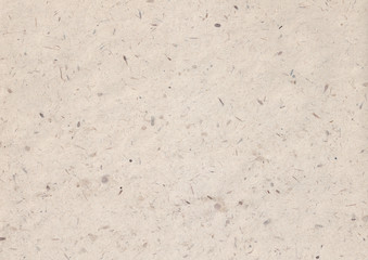 texture of light kraft paper sheet with soft dark brown grain shavings