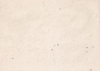 texture of light kraft paper sheet with soft dark brown grain shavings