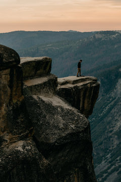 Man Standing at The Edge of A Mountain Cliff in Yosemite