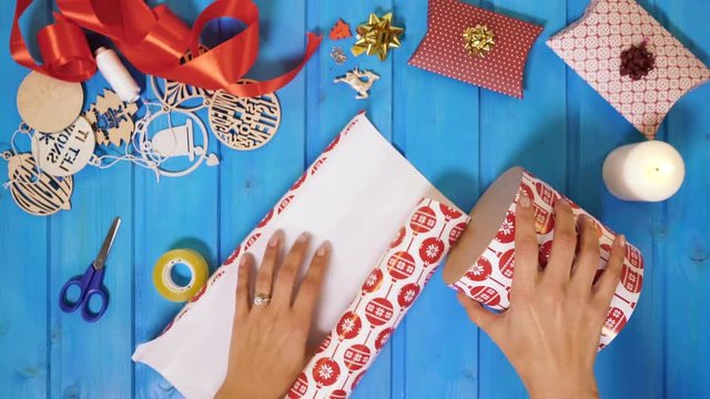Hands wrapping a gift box