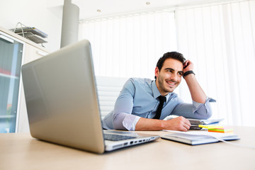 Lonley tiresome businessman spending time at work