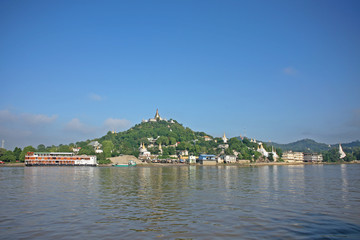 Pagodas gleam on the serene riverbanks of the Irrawaddy in Burma
