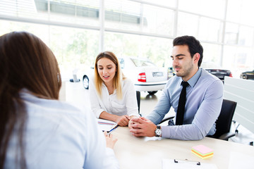 Young couple buying a new car