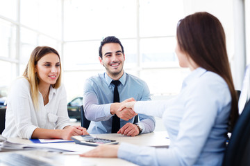 Fototapeta premium A young married couple bought a car