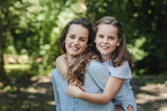 Sweet summer portrait of two happy sisters