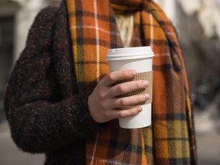 Woman in coat with coffee