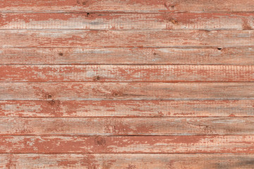 Background of old wooden board with cracked red paint