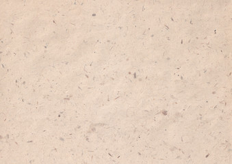 texture of kraft paper sheet with dark brown grain shavings