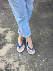 Blue Flip Flop Isolated on Cement Floor,Top view. Beautiful Woman Wearing Blue Shoes and Jeans of Accessory on Concrete Background Great For Any Use.