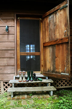 Rubber boots standing on stairs on back porch