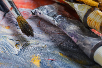 Artist paint brushes on wooden background