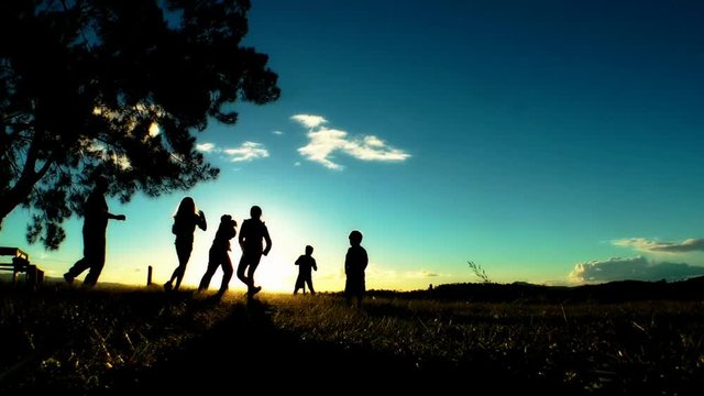Silhouette of a family playing