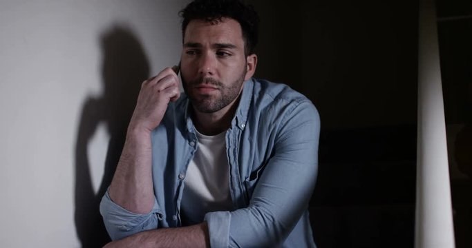 4K Portrait of man in a deep depression making a phone call for help but getting no reply