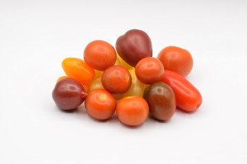 Tiny grape tomatoes in red, orange, yellow, and purple. 