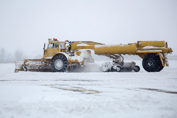 Clearing airport from snow during snow storm. clearing runway from snow. Clearing snow with...