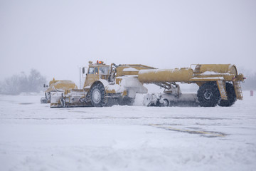 Clearing airport from snow during snow storm. clearing runway from snow. Clearing snow with...