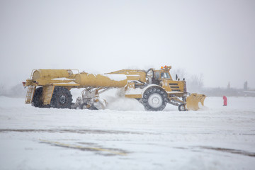 Clearing airport from snow during snow storm. clearing runway from snow. Clearing snow with...