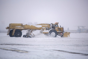 Clearing airport from snow during snow storm. clearing runway from snow. Clearing snow with...