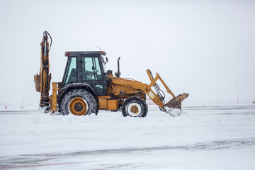 Clearing airport from snow during snow storm. clearing runway from snow. Clearing snow with...