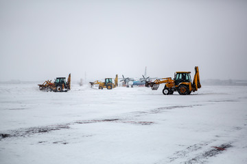 Clearing airport from snow during snow storm. clearing runway from snow. Clearing snow with...