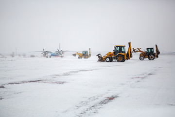 Clearing airport from snow during snow storm. clearing runway from snow. Clearing snow with...