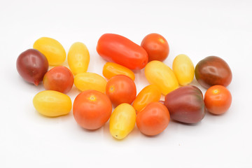 Tiny grape tomatoes in red, orange, yellow, and purple. 
