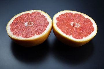 cut grapefruit on a dark background