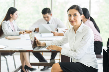 Happy Businesswoman Standing In Front Of meeting project.