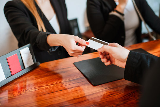 Man Booking Out A Hotel Room With Credit Card