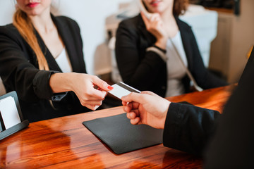 Man booking out a hotel room with credit card