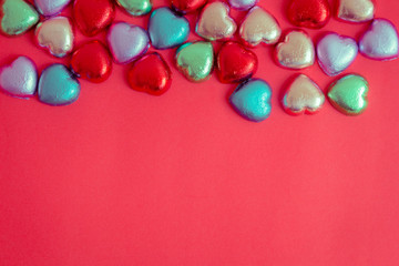 Obraz premium Red background with multicolored heart rests in the concept of Valentine's Day.