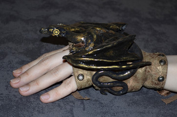 Handmade figurine of steampunk dragon, side view
