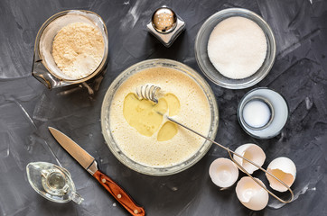 cooking  of Russian dishes pancakes: eggs, milk, flour, butter, salt. Top view