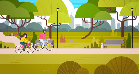 Couple Riding Bicycles In Public Park Over City Building Skyline Background Man And Woman Cycling Outdoors Flat Vector Illustration