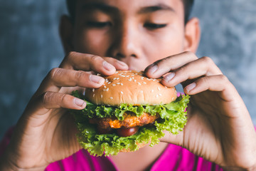 Boys love to eat hamburger.