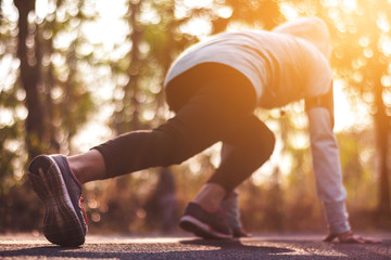 Women runner feet on road in workout wellness concept.