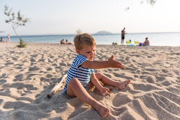 Caucasian boy at summer sandy beach playing