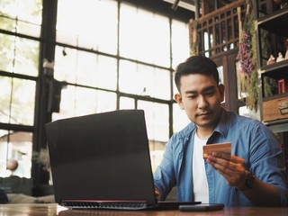 Business man working with laptop at coffee shop.