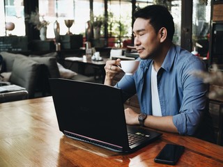 Business man working with laptop at coffee shop.