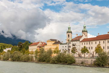 Fototapeta na wymiar Inn river in Innsbruck with Innsbruck Cathedral, Austria