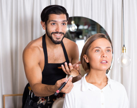 makeup artist applying cosmetics for female