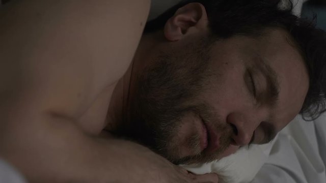 Drunk male sleeping on sofa, breathing with open mouth and snoring loudly